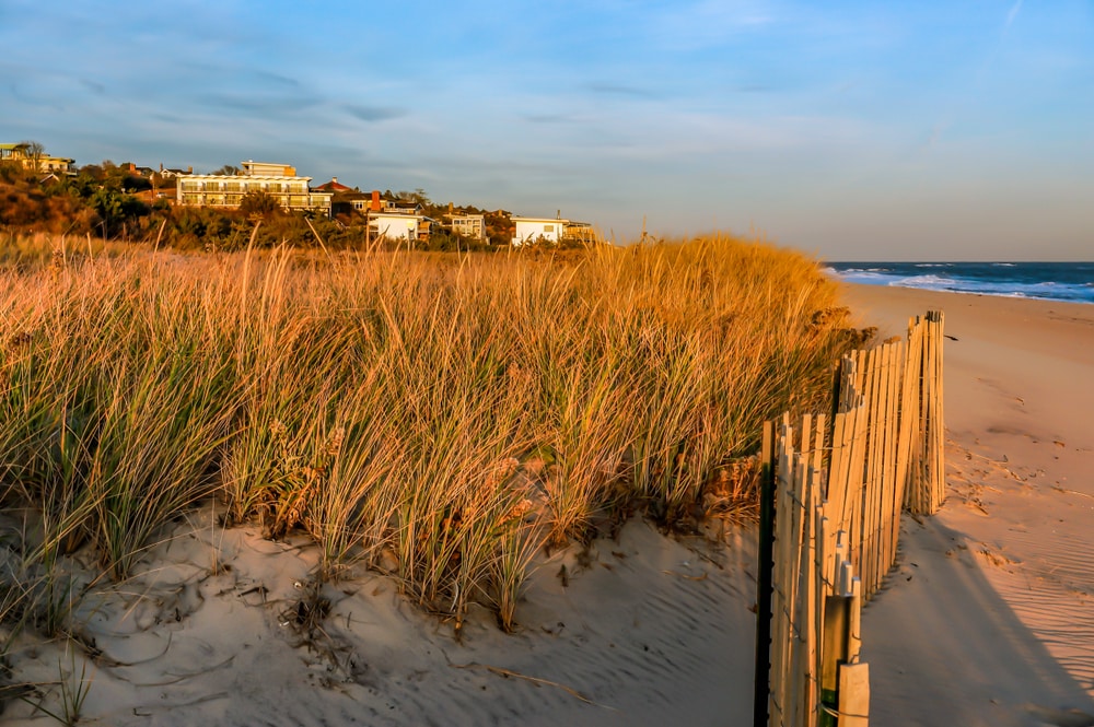 A sunset at Hamptons Beach, one of the best New Hampshire beaches to visit near us.
