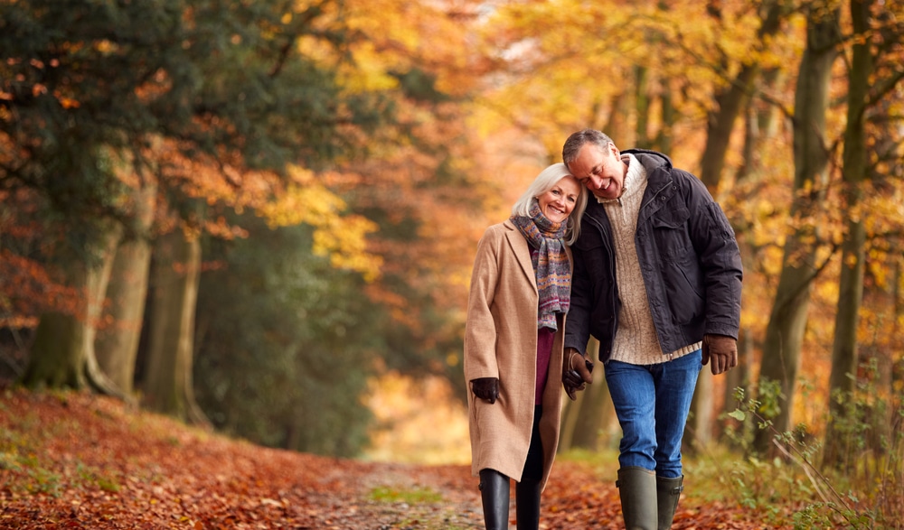 Couple enjoying a walk through beautiful New Hampshire fall foliage