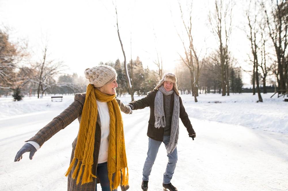 a couple ice skating in winter - one of the many things to do on the Seacoast while enjoying a getaway in New Hampshire