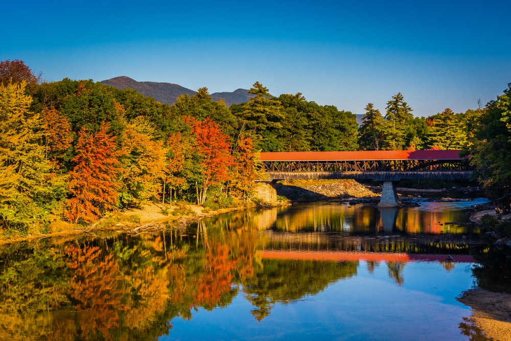 A picturesque example of covered bridges in New Hampshire in fall