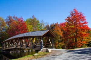 A gorgeous covered bridge in Sunapee during the fall - driving to beautiful spots like this is one of the best things to do in Exeter, NH in the fall