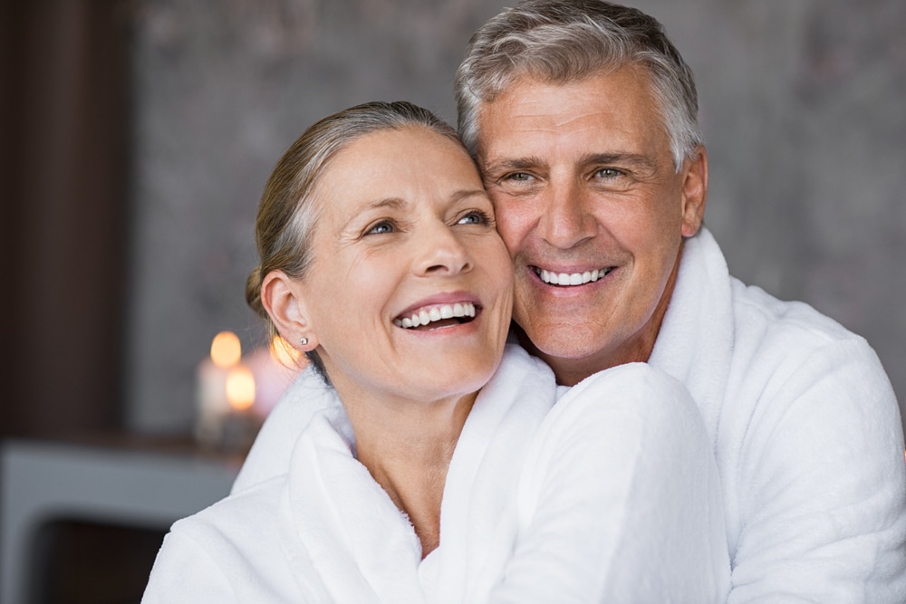 An older couple embraces in their bathrobes before they catch their reservation at one of the top Exeter NH restaurants.